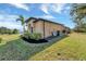 Tan house exterior with manicured lawn and palm trees at 1041 Harbour Park Ct, Punta Gorda, FL 33983