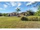 Front view of a tan house with a three-car garage at 1041 Harbour Park Ct, Punta Gorda, FL 33983