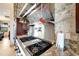 Stainless steel range, hood, and stone backsplash highlight this kitchen at 1041 Harbour Park Ct, Punta Gorda, FL 33983