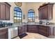 Spacious kitchen with corner sink, granite countertops, and dark wood cabinets at 1041 Harbour Park Ct, Punta Gorda, FL 33983