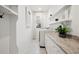 Bright laundry room with built-in shelving and granite countertop at 1099 Cimarron Dr, Punta Gorda, FL 33950