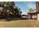 Large backyard with mature trees and screened porch at 1101 Victoria Ave, Port Charlotte, FL 33948