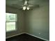 Bedroom with dark hardwood floors, ceiling fan, and large window at 1101 Victoria Ave, Port Charlotte, FL 33948