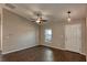 Bright living room with dark hardwood floors, ceiling fan, and window at 1101 Victoria Ave, Port Charlotte, FL 33948