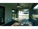 Relaxing screened porch with tile floor, ceiling fan, and sliding glass doors at 1101 Victoria Ave, Port Charlotte, FL 33948