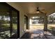 Relaxing screened porch, featuring tile floors and ceiling fan at 1101 Victoria Ave, Port Charlotte, FL 33948