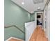 Upstairs hallway with light green walls and wood floors at 1246 Rio De Janeiro Ave # 509, Punta Gorda, FL 33983