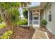 Pathway to a cozy screened porch with landscaping at 1259 Red Oak Ln, Port Charlotte, FL 33948