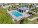 Community pool with lounge chairs and a shaded seating area at 14033 Black Beauty Dr # 511, Punta Gorda, FL 33955