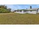 Large backyard with grassy area and home view at 145 Dartmouth Nw Dr, Port Charlotte, FL 33952