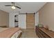 Main bedroom with barn door entry and en-suite bathroom access at 145 Dartmouth Nw Dr, Port Charlotte, FL 33952