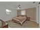 Cozy bedroom with a comfortable bed, side table, and tiled floors at 145 Dartmouth Nw Dr, Port Charlotte, FL 33952