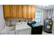 Bright laundry room, washer, dryer, and cabinets at 145 Dartmouth Nw Dr, Port Charlotte, FL 33952