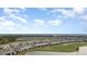 An elevated view of a sprawling planned community with golf course, water views, and green landscaping at 15950 Grassland Ln # 2622, Punta Gorda, FL 33982