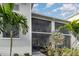 Condo building featuring private screened lanais, lush landscaping and a sidewalk at 15950 Grassland Ln # 2622, Punta Gorda, FL 33982