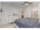 This main bedroom features a ceiling fan, neutral walls, dresser, and ensuite bath at 15950 Grassland Ln # 2622, Punta Gorda, FL 33982