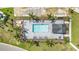 Overhead aerial perspective of a new community pool area, surrounded by palm trees and lounge chairs at 15950 Grassland Ln # 2622, Punta Gorda, FL 33982