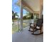 Relaxing rocking chair on a covered front porch at 164 Baldwin Se Ct, Port Charlotte, FL 33952