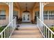 Front porch with rocking chairs and white railings at 164 Baldwin Se Ct, Port Charlotte, FL 33952