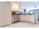 Kitchen features stainless steel dishwasher and light wood cabinets at 164 Baldwin Se Ct, Port Charlotte, FL 33952