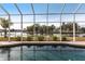 Inviting pool area with screened enclosure overlooking a peaceful canal at 164 Baldwin Se Ct, Port Charlotte, FL 33952