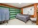 Small bedroom with a single bed, built-in shelving, and wood paneling at 168 Dartmouth Nw Dr, Port Charlotte, FL 33952