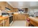 Full kitchen with wood cabinets, built-in microwave, and wood countertops at 168 Dartmouth Nw Dr, Port Charlotte, FL 33952