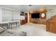 Living area with wood accent wall and vintage furniture at 168 Dartmouth Nw Dr, Port Charlotte, FL 33952