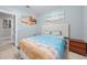 Guest bedroom with a double bed and wood nightstand at 17654 Vellum Cir, Punta Gorda, FL 33955