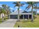 One-story house with metal roof and palm trees at 17654 Vellum Cir, Punta Gorda, FL 33955