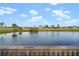 Serene pond view from wooden dock at 17654 Vellum Cir, Punta Gorda, FL 33955