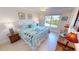 Main bedroom with king-size bed, and window overlooking backyard at 18042 Eau Gallie Cir, Port Charlotte, FL 33948