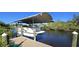 Covered boat lift for pontoon boat on a private dock at 18042 Eau Gallie Cir, Port Charlotte, FL 33948