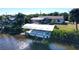 Covered boat lift with pontoon boat, on a canal-side dock at 18042 Eau Gallie Cir, Port Charlotte, FL 33948