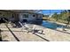 Relaxing poolside patio with chairs and a table at 18042 Eau Gallie Cir, Port Charlotte, FL 33948