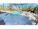 Screened pool and patio with water view at 18042 Eau Gallie Cir, Port Charlotte, FL 33948