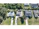 Aerial view of three homes with pools and solar panels, showcasing a desirable neighborhood at 18395 Edgewater Dr, Port Charlotte, FL 33948