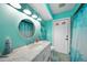 Bathroom with teal walls, seashell shower curtain, and white vanity at 18395 Edgewater Dr, Port Charlotte, FL 33948