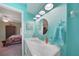 Bathroom with marble vanity, teal walls, and beach-themed decor at 18395 Edgewater Dr, Port Charlotte, FL 33948