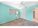 Bedroom with light teal walls, ceiling fan, and neutral carpeting at 18395 Edgewater Dr, Port Charlotte, FL 33948