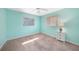 Bedroom with light teal walls, ceiling fan, and neutral carpeting at 18395 Edgewater Dr, Port Charlotte, FL 33948