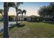 Single-story home with palm trees and a well-manicured lawn at 18395 Edgewater Dr, Port Charlotte, FL 33948