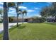 Single story house with a well-maintained lawn and palm trees at 18395 Edgewater Dr, Port Charlotte, FL 33948