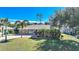 Single-story house with stone accents and palm trees at 18395 Edgewater Dr, Port Charlotte, FL 33948