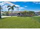 Single-story house with stone accents and lush lawn at 18395 Edgewater Dr, Port Charlotte, FL 33948