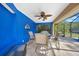 Relaxing covered patio with seating area and blue walls at 18395 Edgewater Dr, Port Charlotte, FL 33948