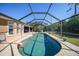 Inviting screened pool area with ample deck space for lounging at 18395 Edgewater Dr, Port Charlotte, FL 33948