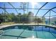 Inviting screened-in pool with surrounding lush greenery at 18395 Edgewater Dr, Port Charlotte, FL 33948