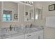 Double vanity bathroom with granite countertops and modern fixtures at 1848 Bobcat Trl, North Port, FL 34288