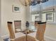 Small dining area with wicker chairs and a glass-top table at 1848 Bobcat Trl, North Port, FL 34288